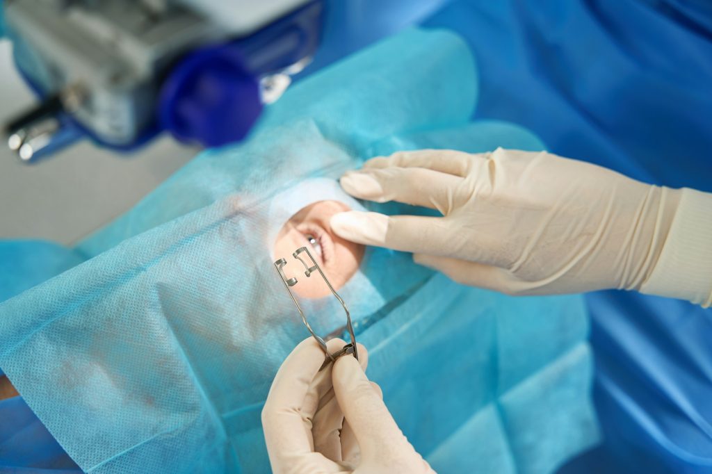 Close-up photo of doctor holding eyelid expander during surgery